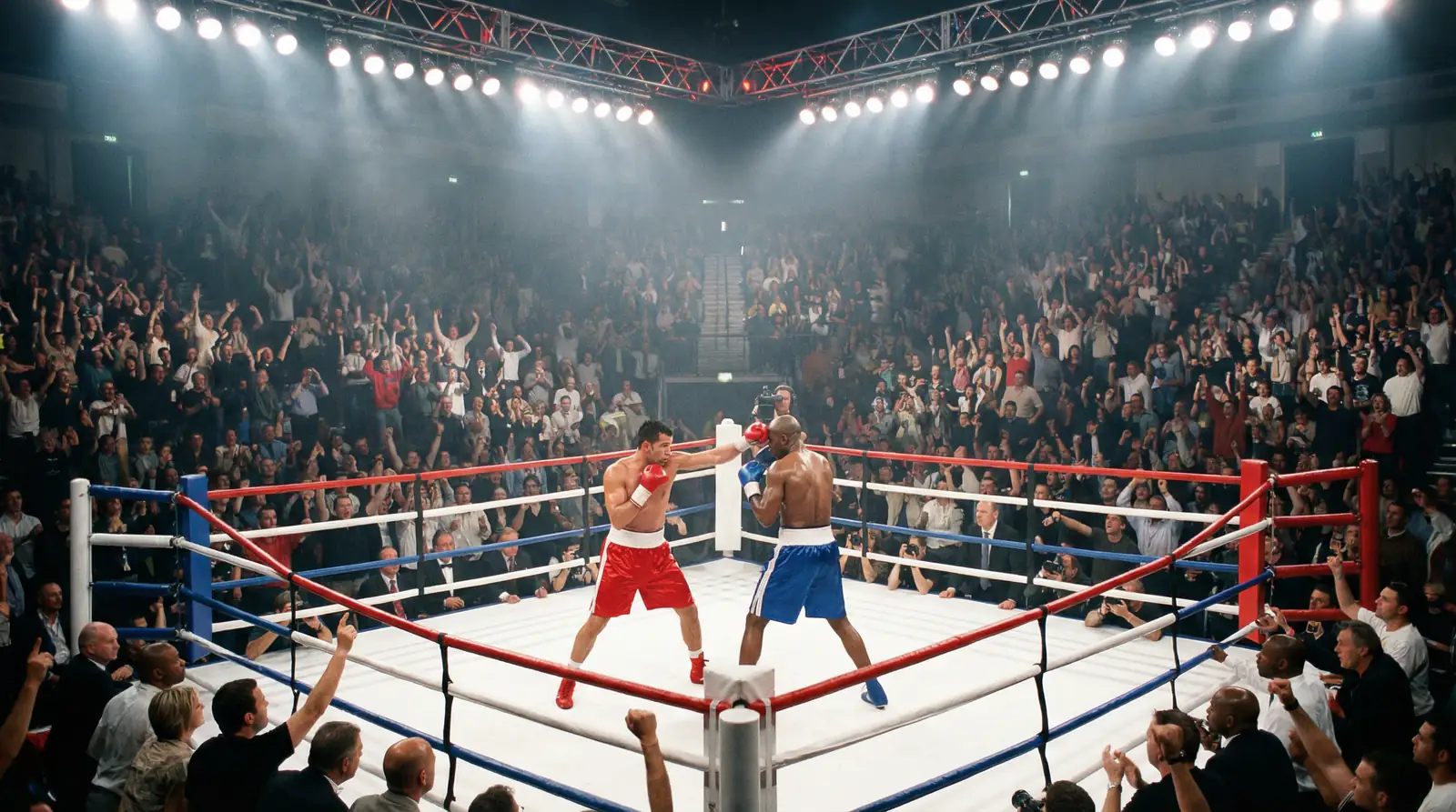 Combate de boxeo en vivo con público animando desde las gradas del recinto